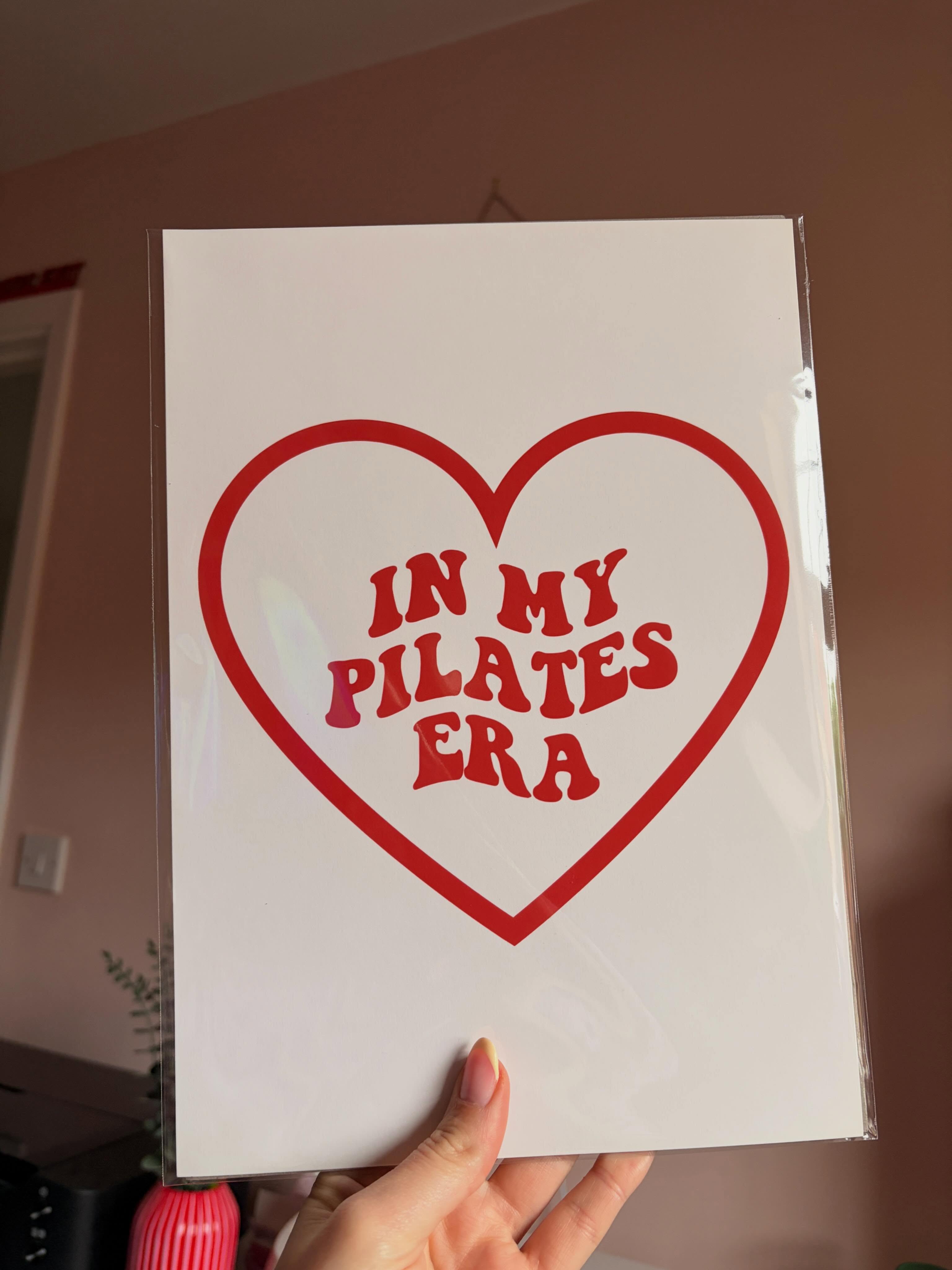White print with a red heart reading 'In My Pilates Era'